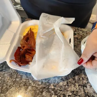 a person holding a fork over a plate of food