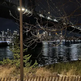 a view of the brooklyn bridge at night
