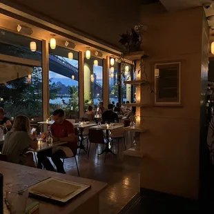 people sitting at tables in a restaurant