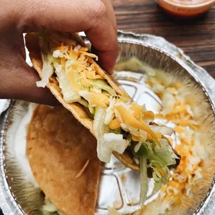 a hand holding a taco