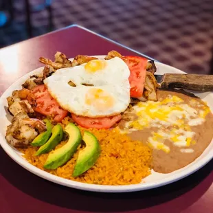 Steak a la Mexicana with 2 eggs over easy served with rice and beans