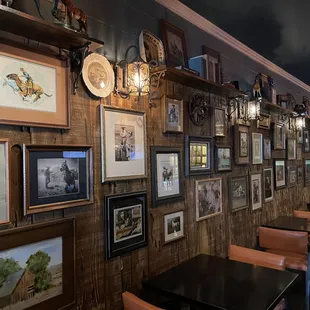 a wall of framed art