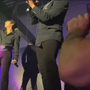 Security guard enjoying his drink and the show while the crowd crushes a concert goer into her wheelchair steps away.