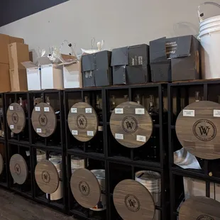a wall of barrels with labels on them