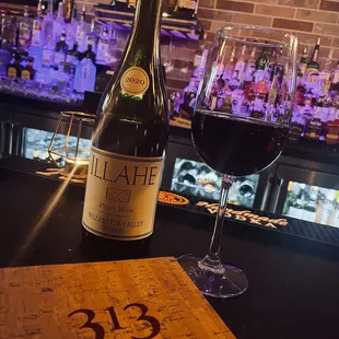 a bottle of wine and a glass of wine