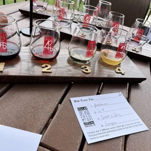 a flight of wine glasses on a wooden table