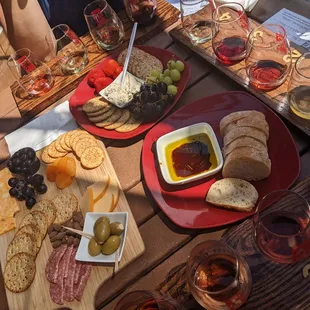 Charcuterie board, wine flights, soft spreadable cheese with assorted seasonal fruits and ciabatta bread with dipping oil