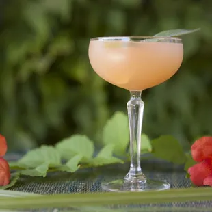 a glass of wine and flowers