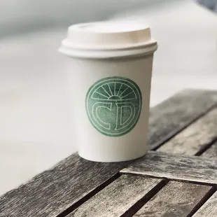 a cup of coffee on a wooden table
