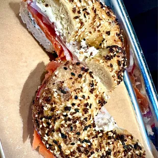 Amazing boiled everything bagel with salmon, cream cheese, red onion and radish.
