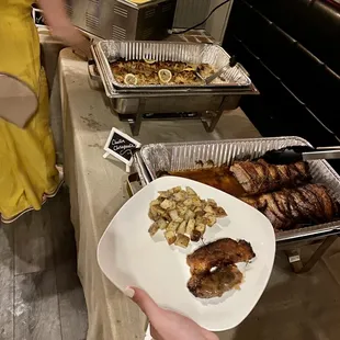 a person holding a plate of food