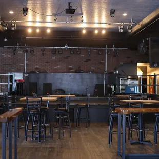 a bar with wooden tables and stools