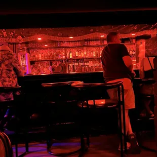 a man and a woman sitting at a bar