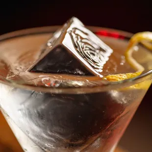 a glass of vodka with ice cubes