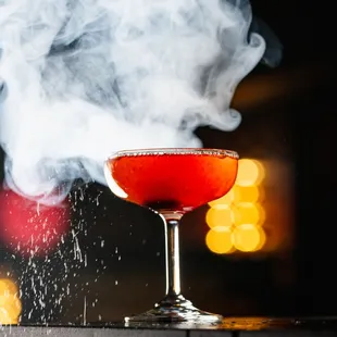 a smoke billowing from a glass