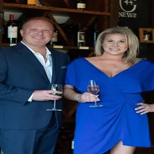 a man and a woman holding wine glasses