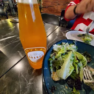 Caesar salad and orange soda