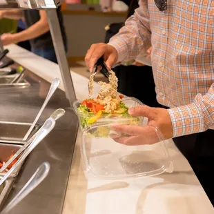 a man serving a salad