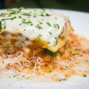 a plate of lasagna on a white plate