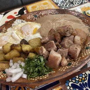 Carnitas breakfast plate. Pork.