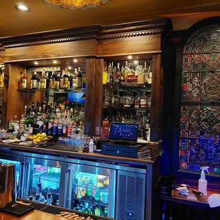 Love the stained glass window behind the bar!