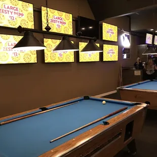 a pool table and televisions