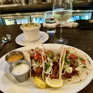 Taco Trio , Fresh caught Cod on a flour tortilla, w chihuahua cheese, lettuce , pico, sour cream, salsa arbol , side of Mac, &amp; pinot Grigio