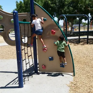 Look beyond the rock climbing wall and you will see a swing set with no swings. How convenient!