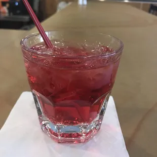 a drink in a glass on a napkin