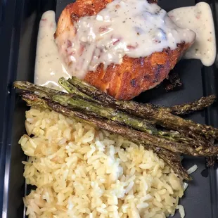 Grilled salmon with rice pilaf and asparagus and a creamy dill sauce