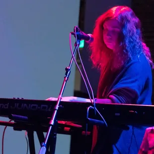 a woman playing a keyboard