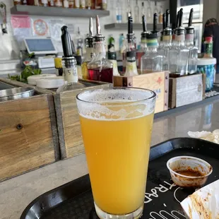 a glass of beer on a tray