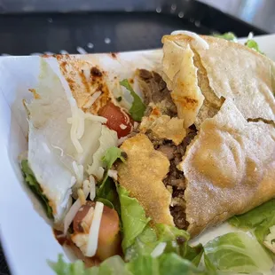 a sandwich on a plate with lettuce and tomato