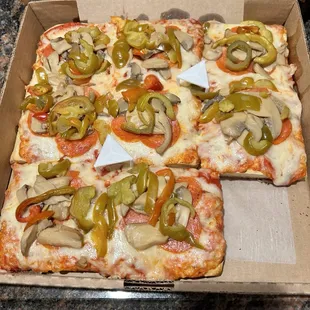 Sicilian pizza with pepperoni, mushrooms, and peppers.