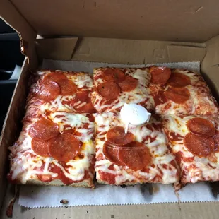 pepperoni and cheese pizza in a box
