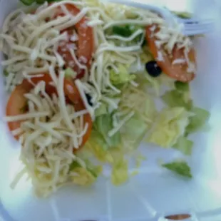 a salad in a styrofoam container