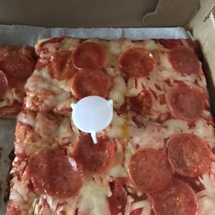 a slice of pepperoni pizza in a box