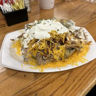 Loaded baked potato with pulled pork and all the fixings