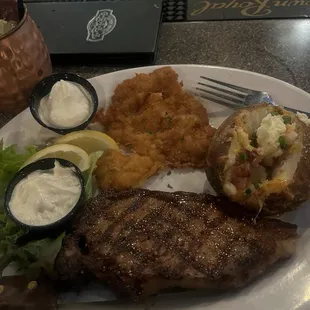 Surf and Turf 9oz NY , calamari steak , loaded baked potato
