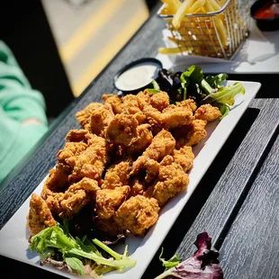 a plate of fried chicken and french fries