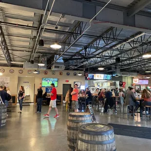 people sitting at tables and watching televisions