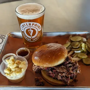 a tray of food and a glass of beer