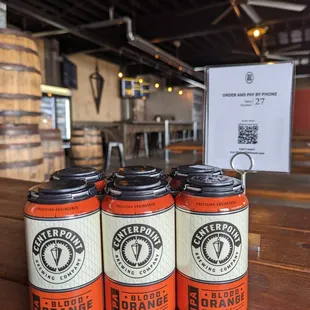 three cans of beer on a table