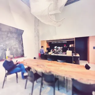 Communal table, chandelier, artwork, coffee bar