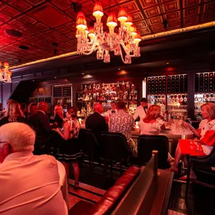 a group of people sitting at a bar