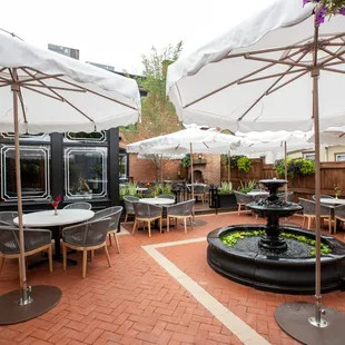 a patio with tables and umbrellas