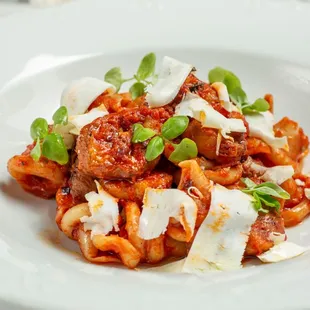 a plate of pasta with meat and cheese