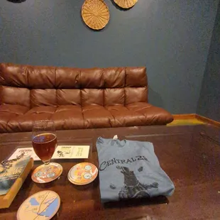 a leather couch with a t - shirt on it