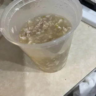 a plastic cup of soup