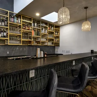 a bar with black chairs